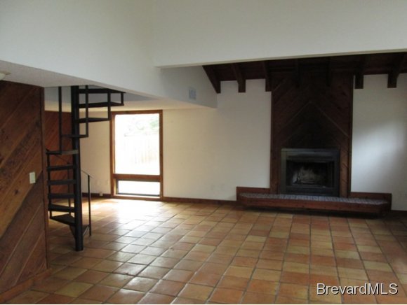 4304 Crooked Mile Road Merritt Island, FL 32952 - Photo 3 of 16 a view of an empty room with a fireplace and a window