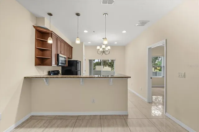 a view of a kitchen with a sink and chandelier