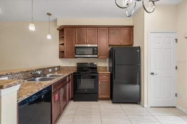 a kitchen with a refrigerator sink and cabinets