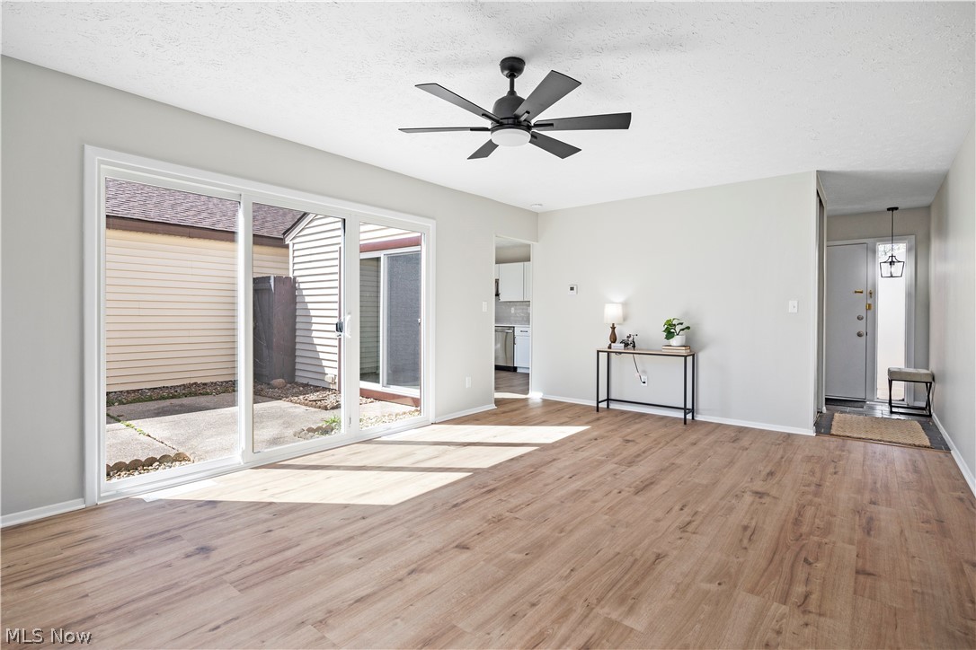32969 Mills Road North Ridgeville, OH 44039 - Photo 7 of 29 Unfurnished room with a wealth of natural light, ceiling fan, and light wood-type flooring
