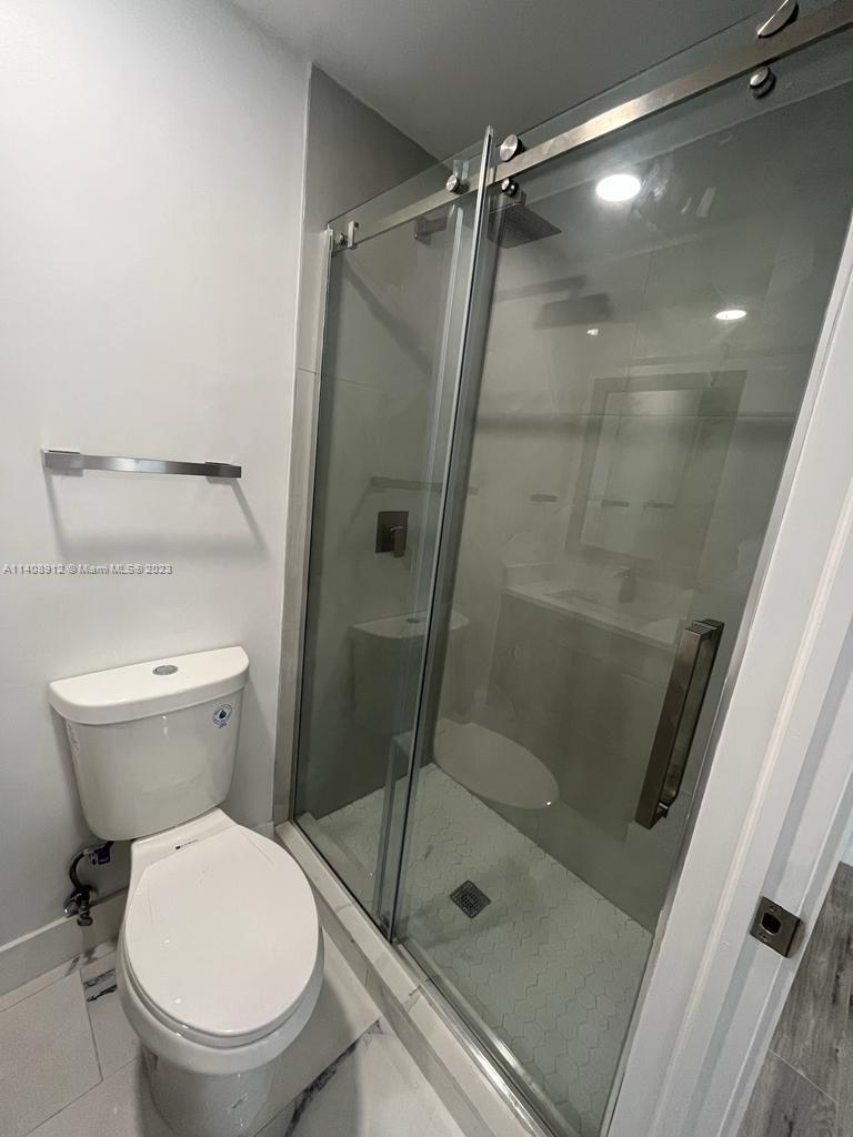 Heathgate Street Tamarac, FL 33321 - Photo 11 of 23 a bathroom with a shower and a toilet