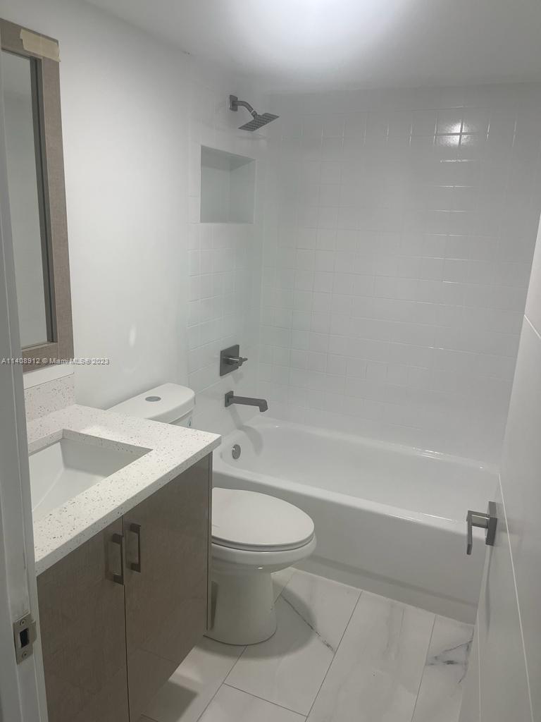 Heathgate Street Tamarac, FL 33321 - Photo 12 of 23 a bathroom with a sink a toilet and a bathtub