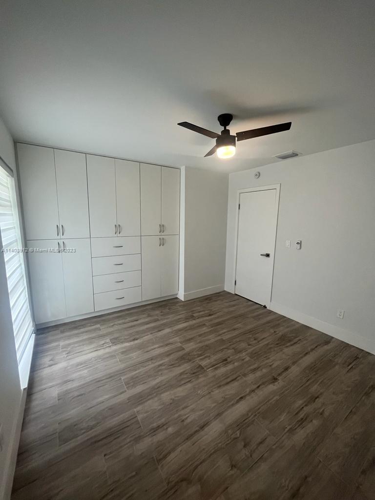 Heathgate Street Tamarac, FL 33321 - Photo 14 of 23 a view of empty room with wooden floor and fan