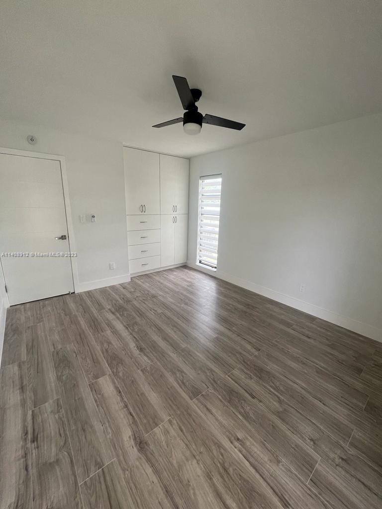Heathgate Street Tamarac, FL 33321 - Photo 16 of 23 a view of empty room with wooden floor and fan