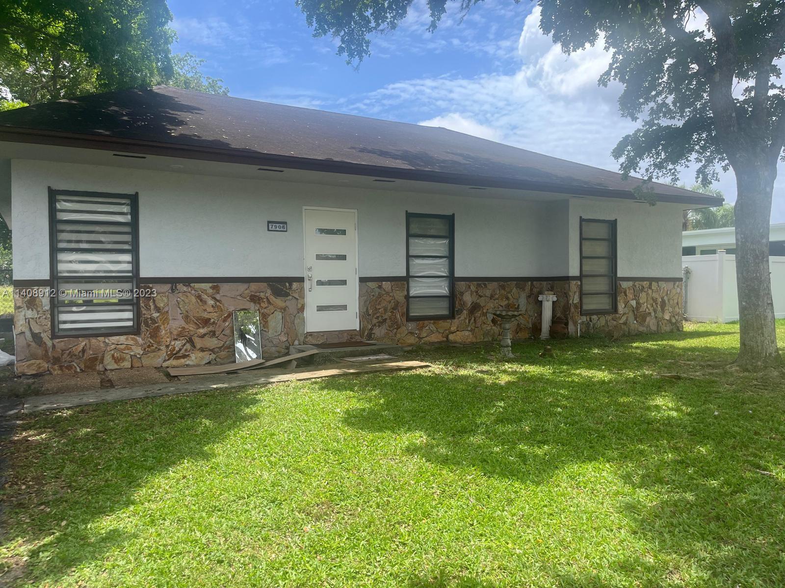 Heathgate Street Tamarac, FL 33321 - Photo 18 of 23 a front view of a house with a yard