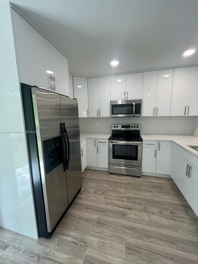 Heathgate Street Tamarac, FL 33321 - Photo 3 of 23 a kitchen with sink a microwave and refrigerator