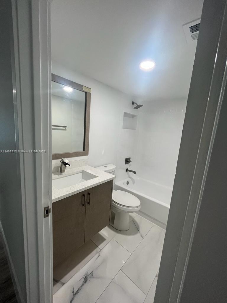 Heathgate Street Tamarac, FL 33321 - Photo 9 of 23 a view of bathroom with a sink and mirror