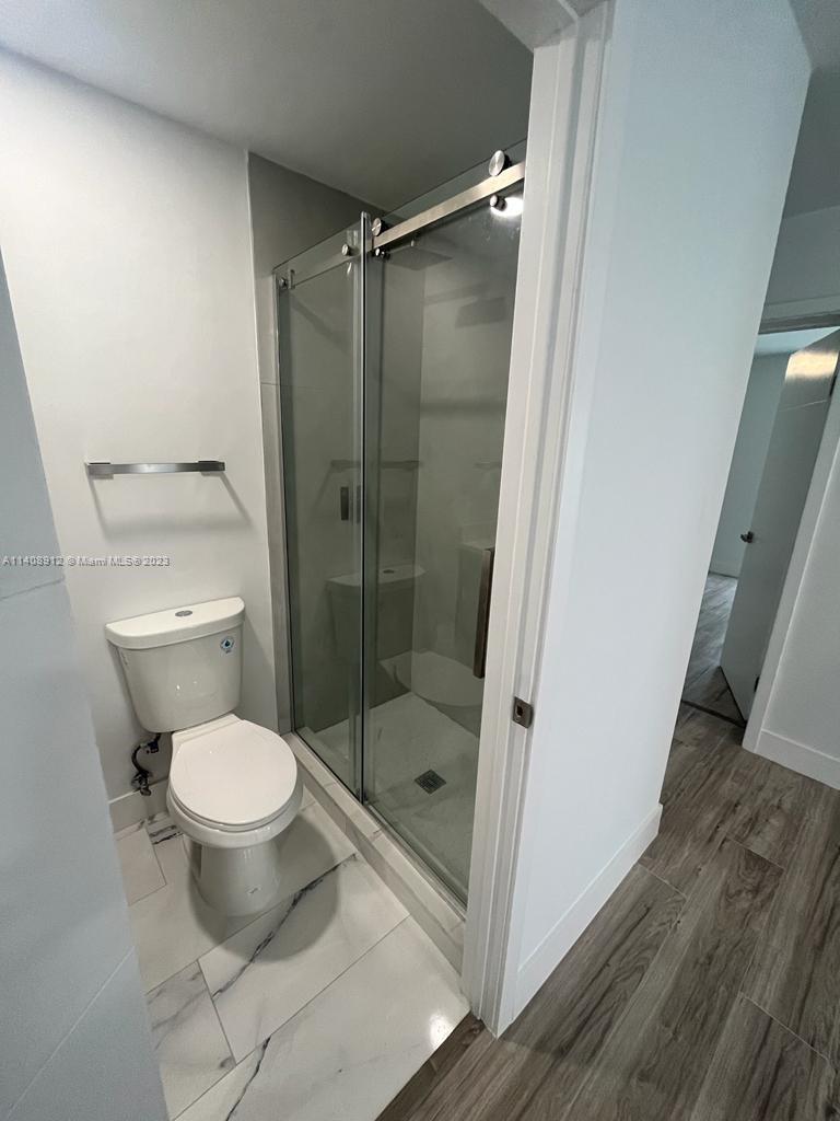 Heathgate Street Tamarac, FL 33321 - Photo 10 of 23 a bathroom with a toilet and a shower