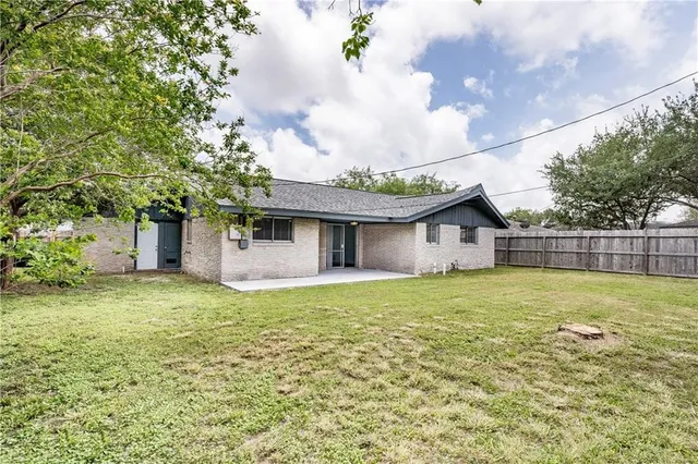 a front view of house with yard and trees
