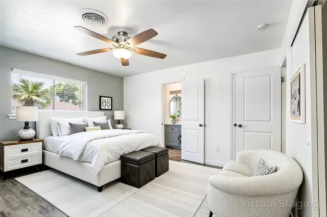 a bedroom with a bed and ceiling fan