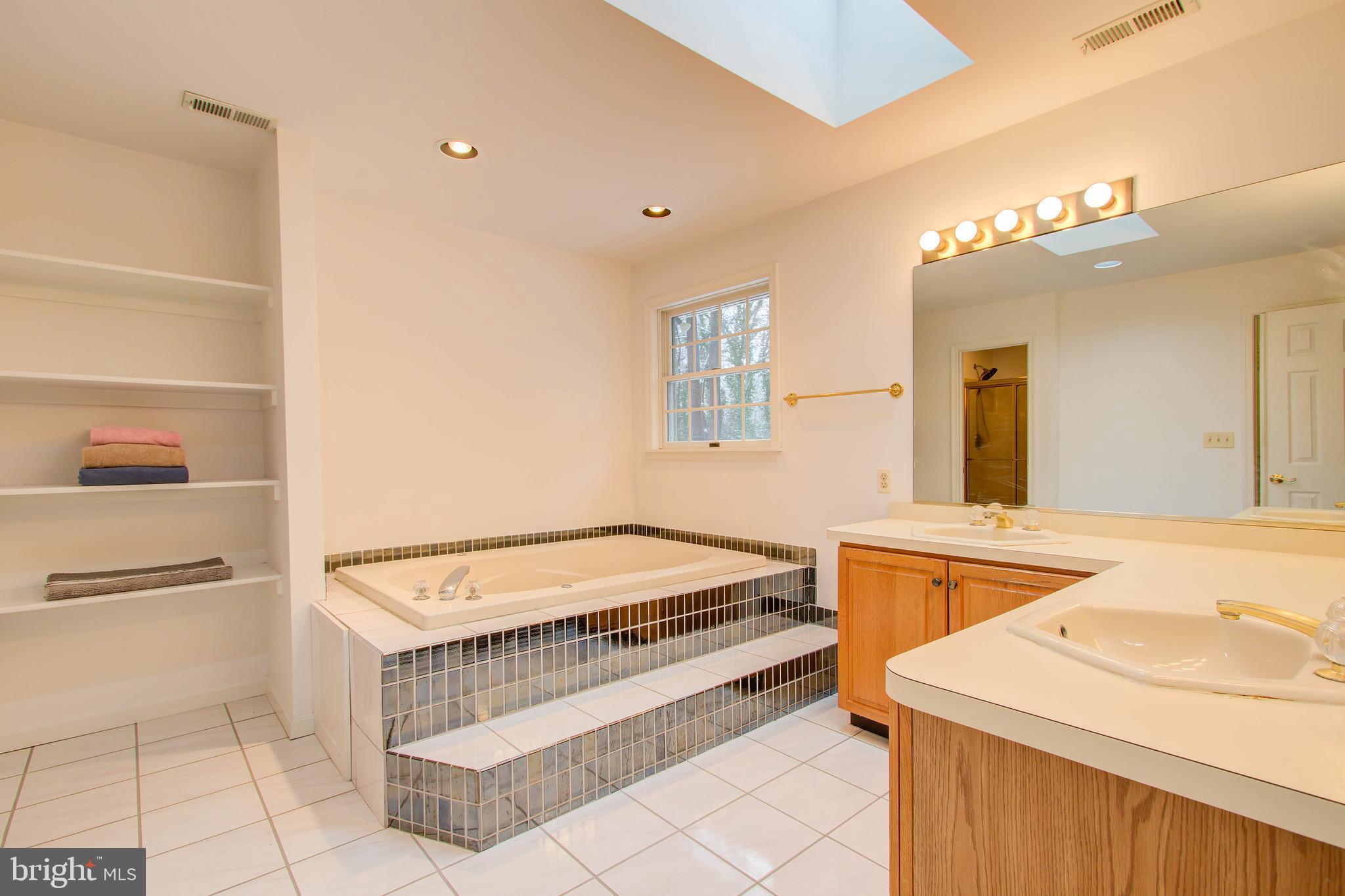 8308 Patapsco Road Pasadena, MD 21122 - Photo 16 of 25 Owners soaking tub, double vanity & skylight