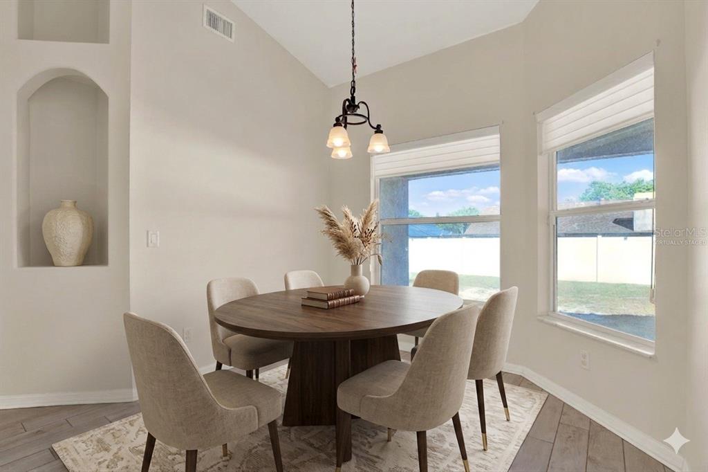 4400 Dior Road Spring Hill, FL 34609 - Photo 19 of 37 a dining room with furniture and window
