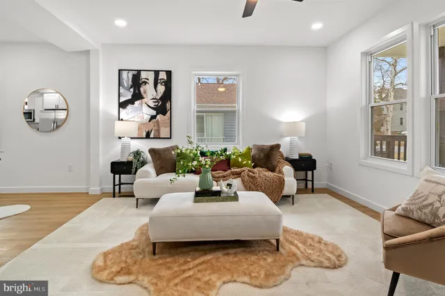 a kitchen with a table chairs refrigerator and microwave
