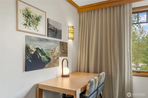 a bedroom with a large bed and a flat screen tv