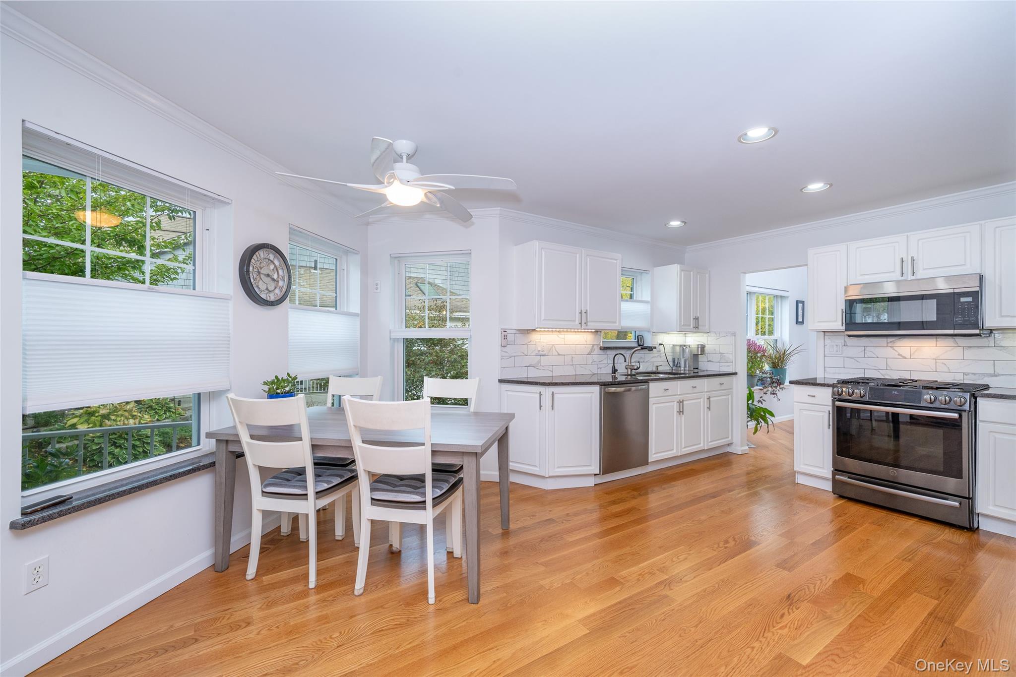 9 High Ridge Road Ossining, NY 10562 - Photo 10 of 50 a kitchen with stainless steel appliances granite countertop a stove top oven a sink dishwasher and a dining table with wooden floor