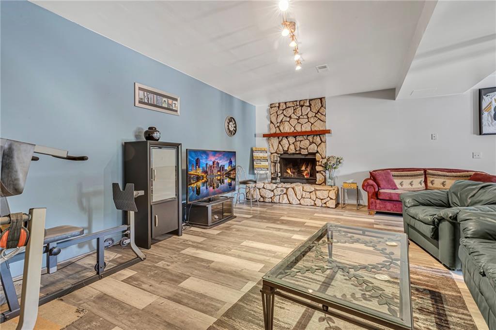 303 Sharon Grange Road Aliquippa, PA 15001 - Photo 19 of 50 Wow. You can't need more space than this for your family/game room. Notice the wood burning fireplace.