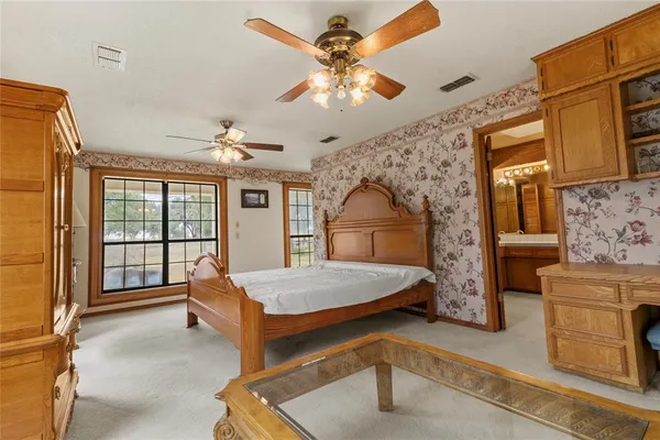 a living room with a bed furniture and a large window