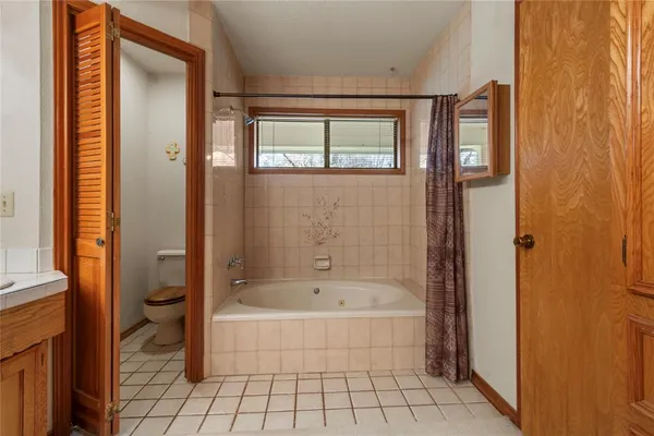 a spacious bathroom with a bathtub and a shower