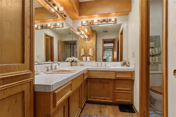 a bathroom with a sink and a mirror with bathtub