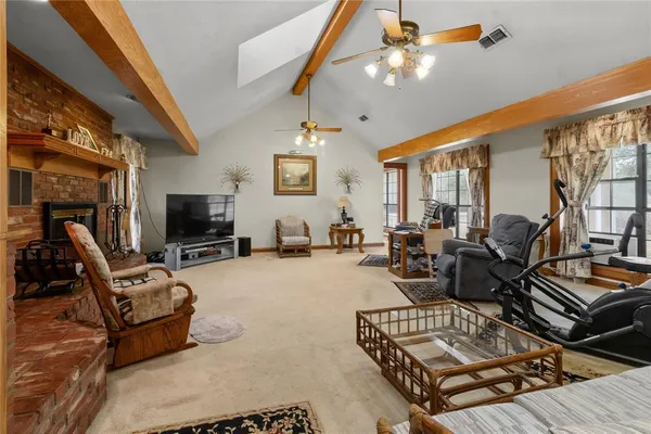 a living room with furniture fireplace and a flat screen tv