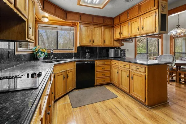a kitchen with stainless steel appliances granite countertop a sink stove and cabinets