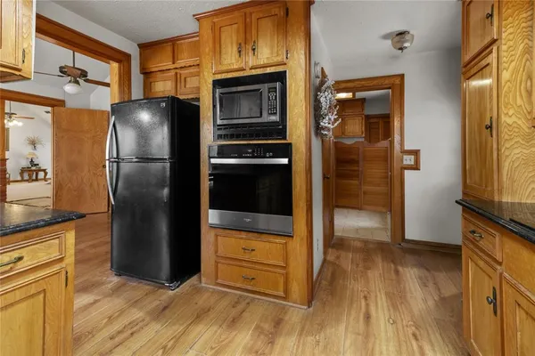 a kitchen with a refrigerator and a stove top oven