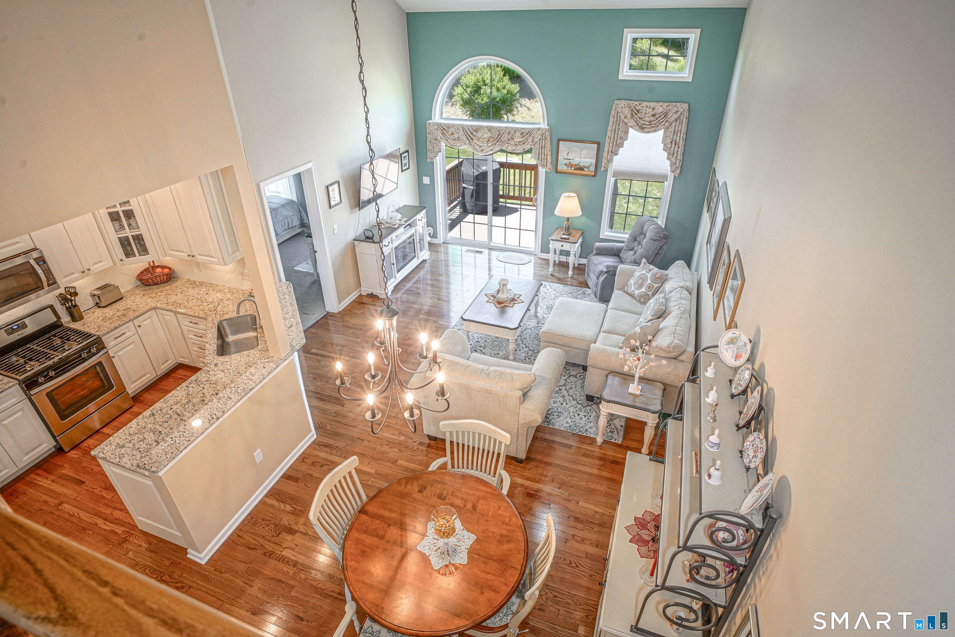 6 Lilac Lane, Unit 6 Prospect, CT 06712 - Photo 3 of 40 View from the upper-level balcony - Main living area flows from dining-kitchen to living room with sliders to deck.