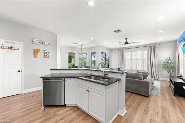 a kitchen with a sink and living room