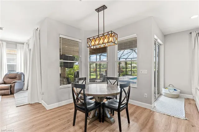 a dining room with furniture wooden floor a chandelier