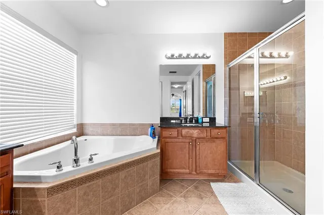 a large spacious bathroom with a bathtub and a shower