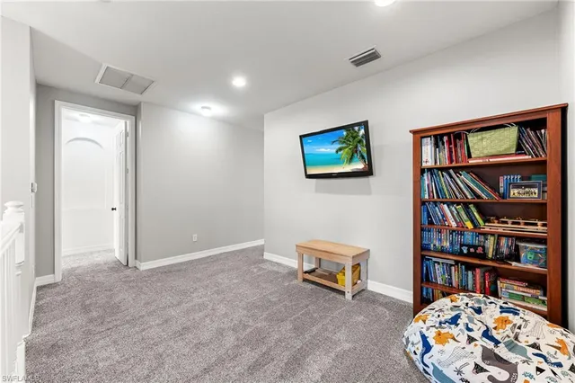 a living room with bookshelf and book shelf