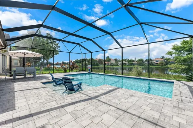 a view of a patio with a table and chairs under an umbrella