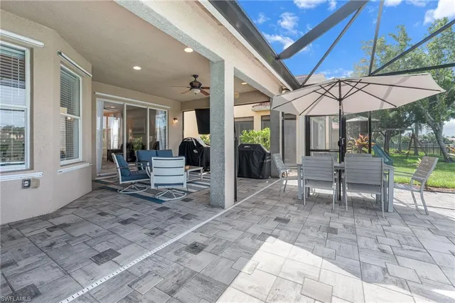 a view of a patio with table and chairs under an umbrella