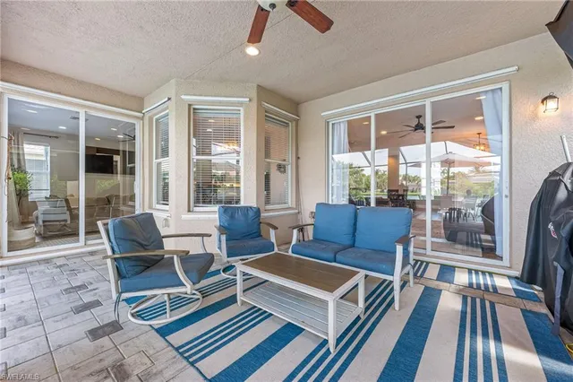 a living room with furniture and a floor to ceiling window
