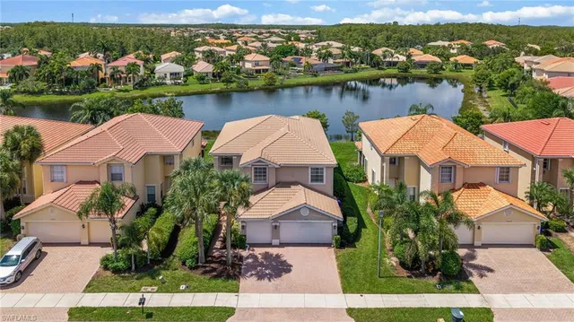 an aerial view of residential houses with outdoor space and river