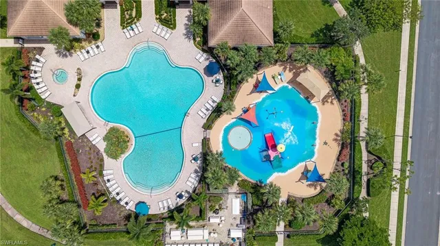 an aerial view of a swimming pool patio and outdoor seating