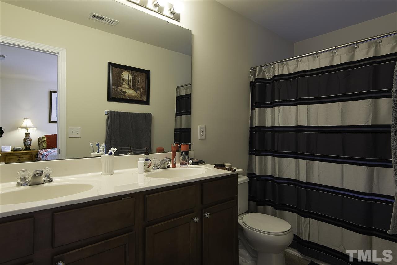 2912 Berkeley Springs Place Raleigh, NC 27616 - Photo 12 of 19 a bathroom with a sink toilet and shower
