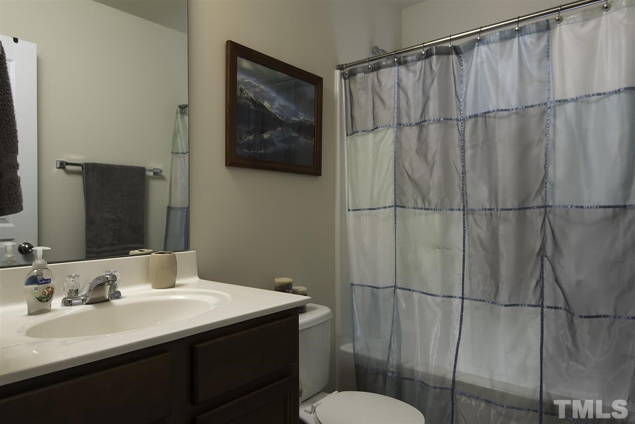 2912 Berkeley Springs Place Raleigh, NC 27616 - Photo 15 of 19 a bathroom with a sink vanity mirror and toilet