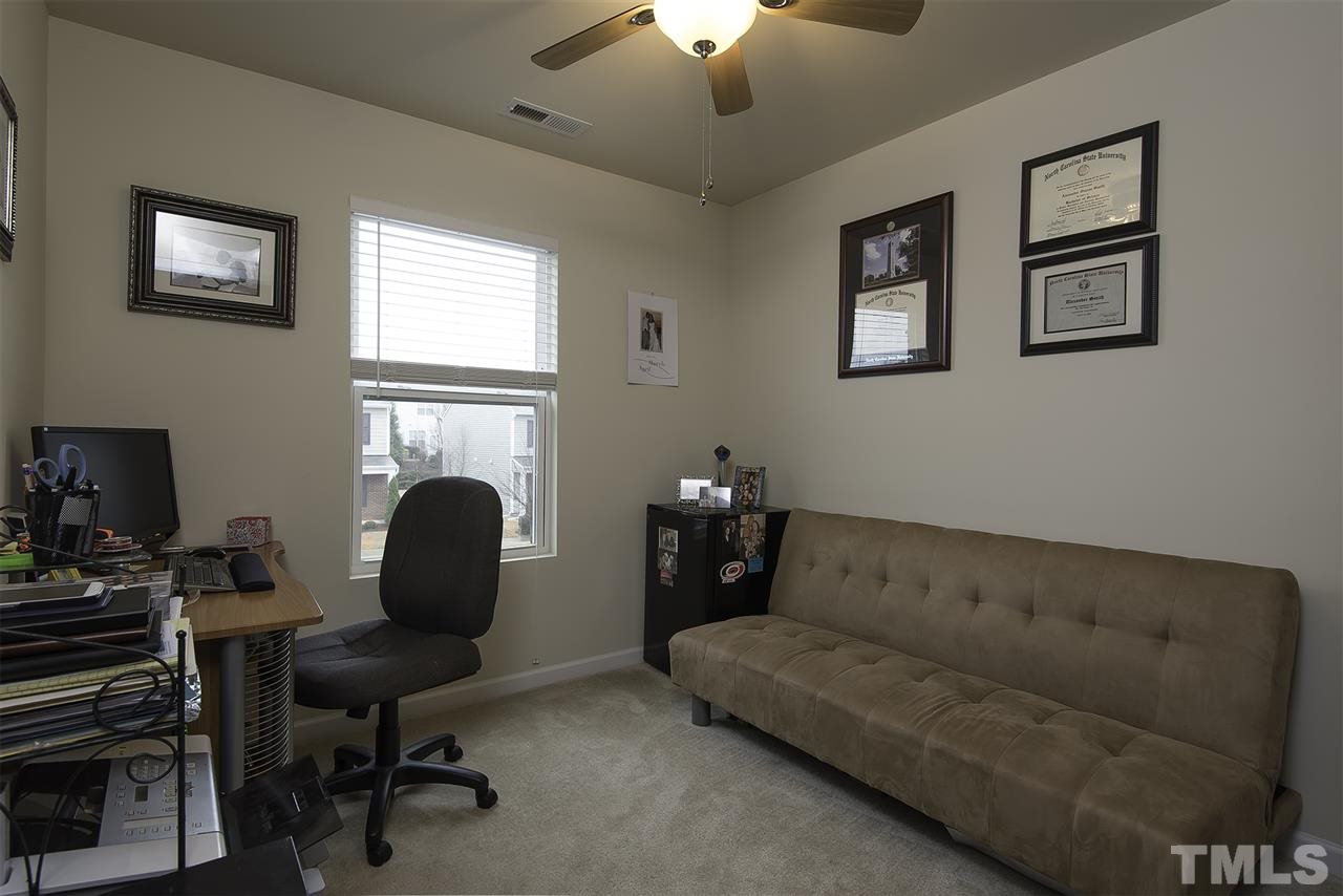 2912 Berkeley Springs Place Raleigh, NC 27616 - Photo 16 of 19 a living room with furniture and a fireplace