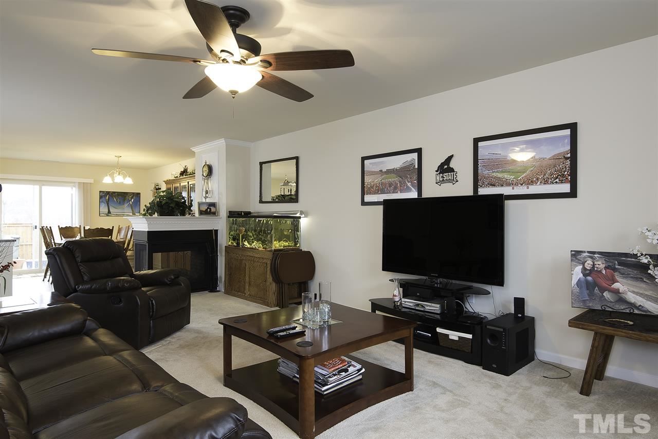 2912 Berkeley Springs Place Raleigh, NC 27616 - Photo 3 of 19 a living room with furniture and a flat screen tv