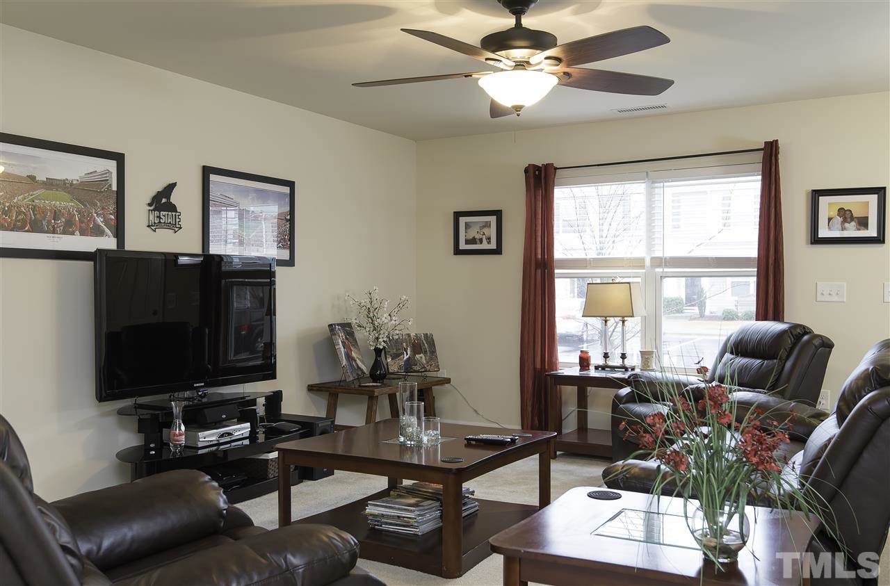 2912 Berkeley Springs Place Raleigh, NC 27616 - Photo 4 of 19 a living room with furniture a flat screen tv and a window