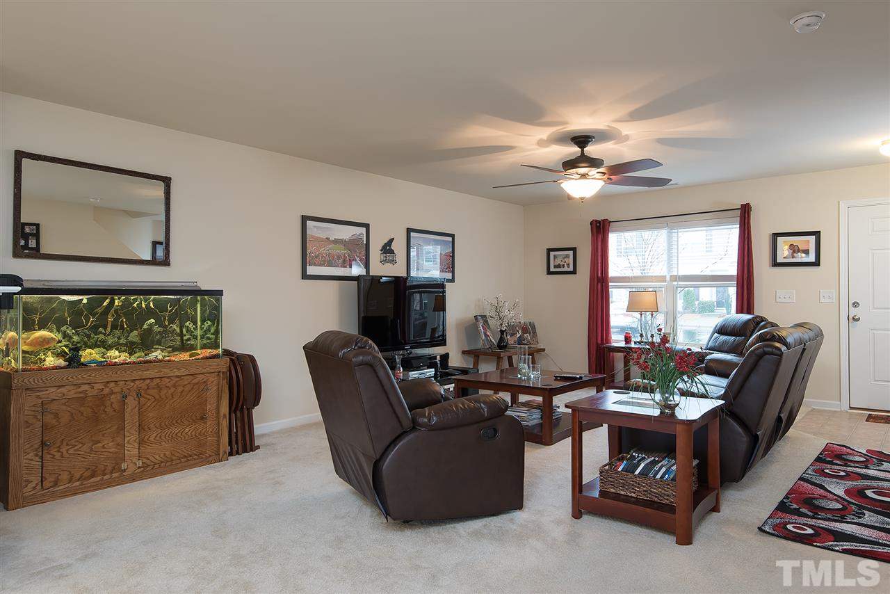 2912 Berkeley Springs Place Raleigh, NC 27616 - Photo 5 of 19 a living room with furniture and a large window