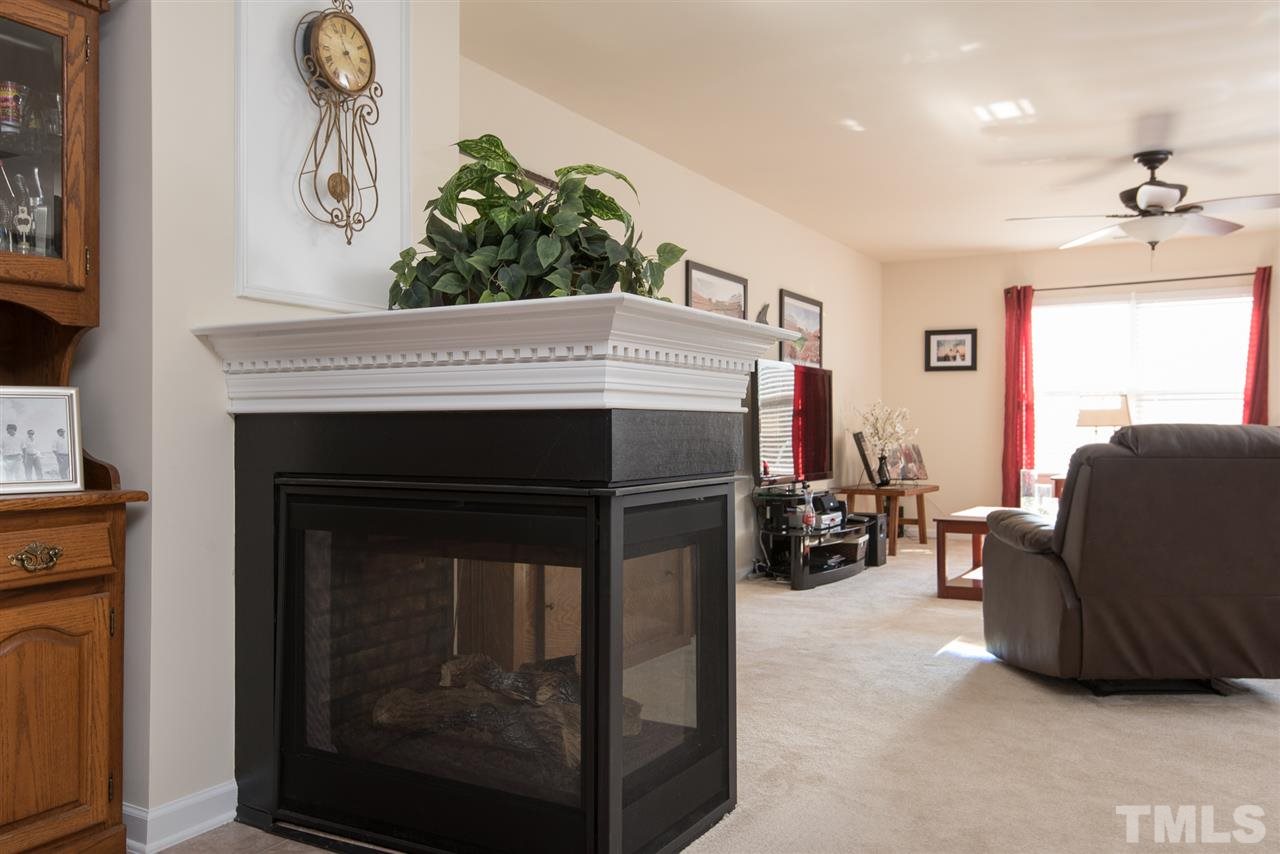2912 Berkeley Springs Place Raleigh, NC 27616 - Photo 6 of 19 a living room with furniture and a fireplace