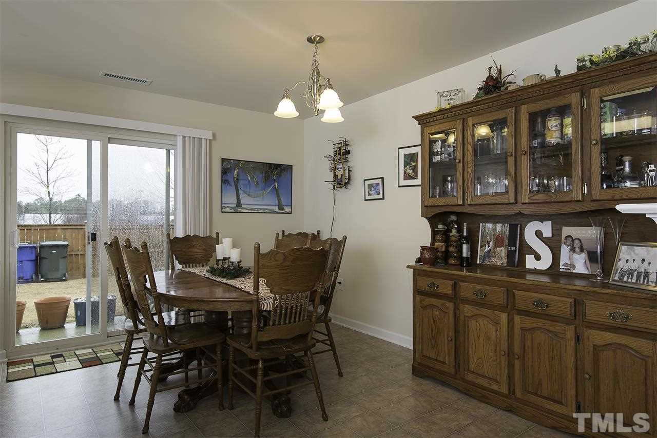 2912 Berkeley Springs Place Raleigh, NC 27616 - Photo 7 of 19 a view of a dining room with furniture window and wooden floor
