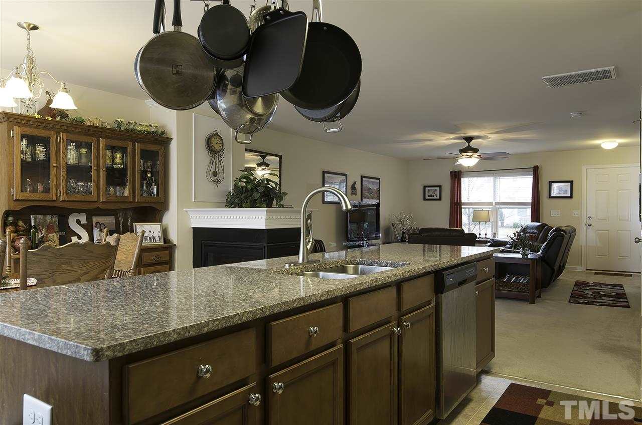 2912 Berkeley Springs Place Raleigh, NC 27616 - Photo 10 of 19 a kitchen with granite countertop a sink a stove and cabinets