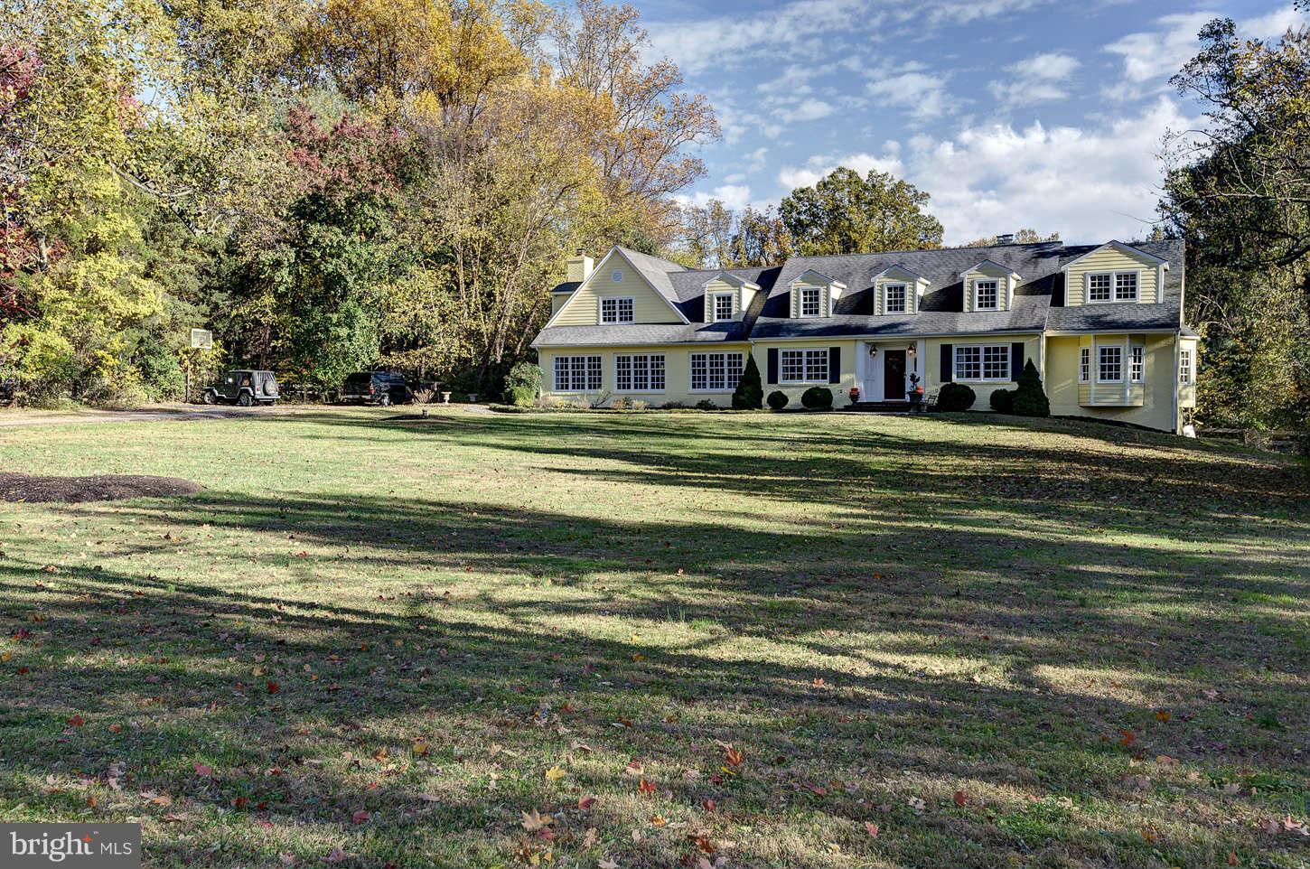 10017 Chapel Road Potomac, MD 20854 - Photo 2 of 26 a front view of a house with a garden