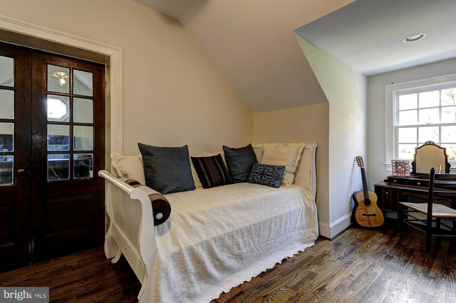 10017 Chapel Road Potomac, MD 20854 - Photo 12 of 26 a bedroom with a bed a table and windows