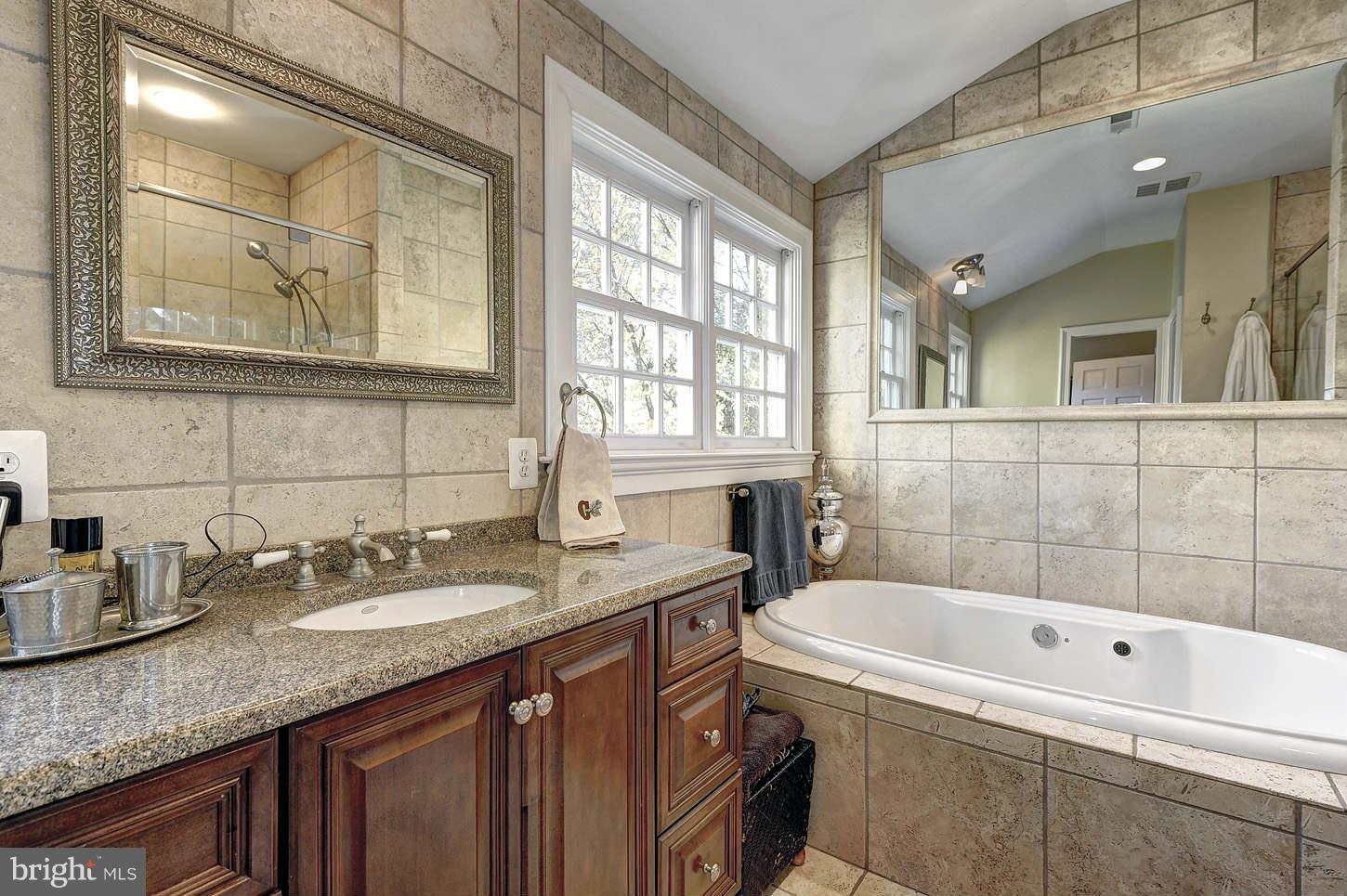 10017 Chapel Road Potomac, MD 20854 - Photo 13 of 26 a bathroom with a granite countertop tub sink and mirror