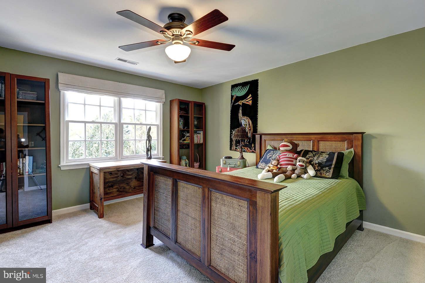10017 Chapel Road Potomac, MD 20854 - Photo 17 of 26 a bedroom with a bed and a large window