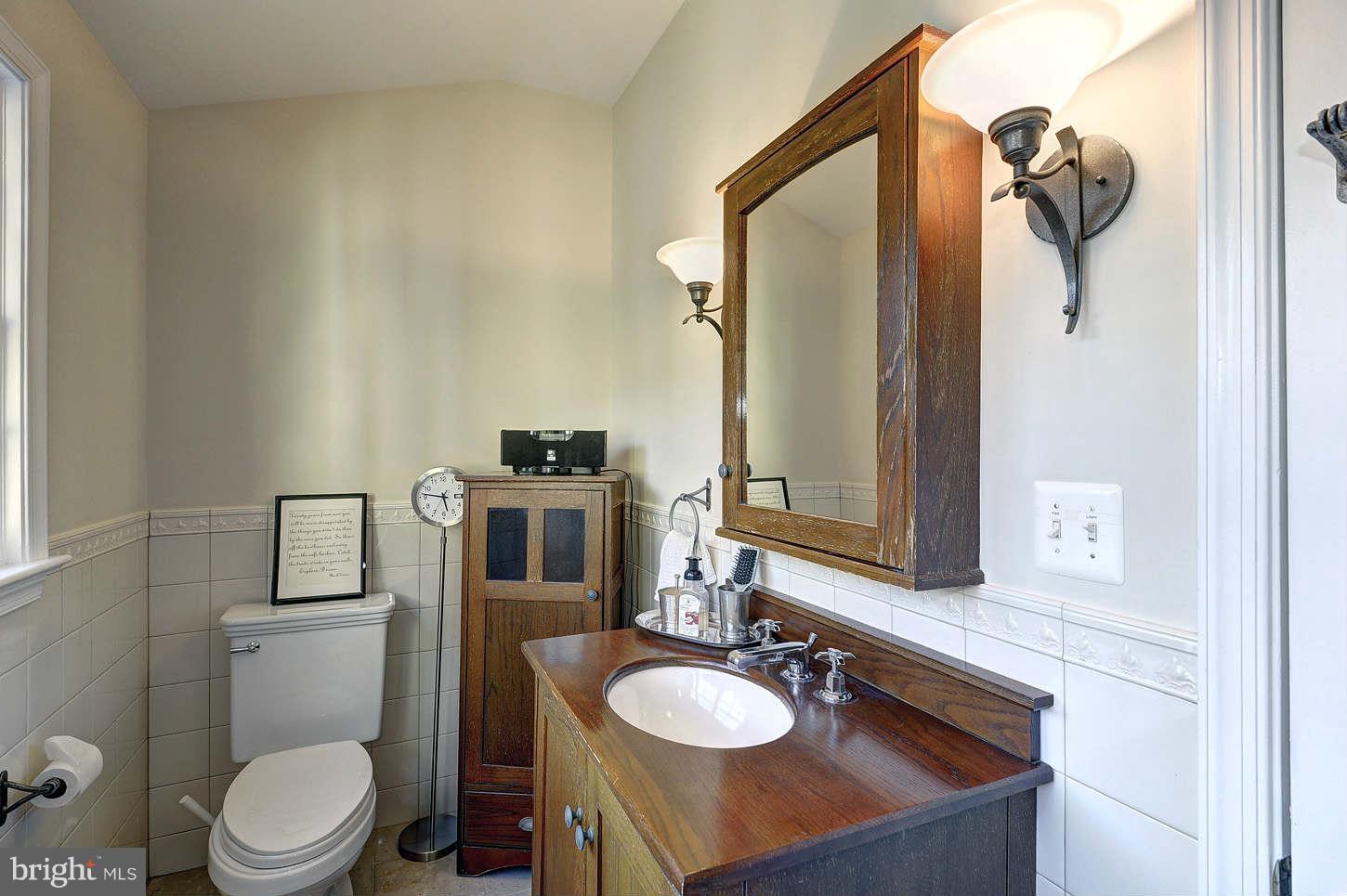 10017 Chapel Road Potomac, MD 20854 - Photo 18 of 26 a bathroom with a sink toilet and mirror